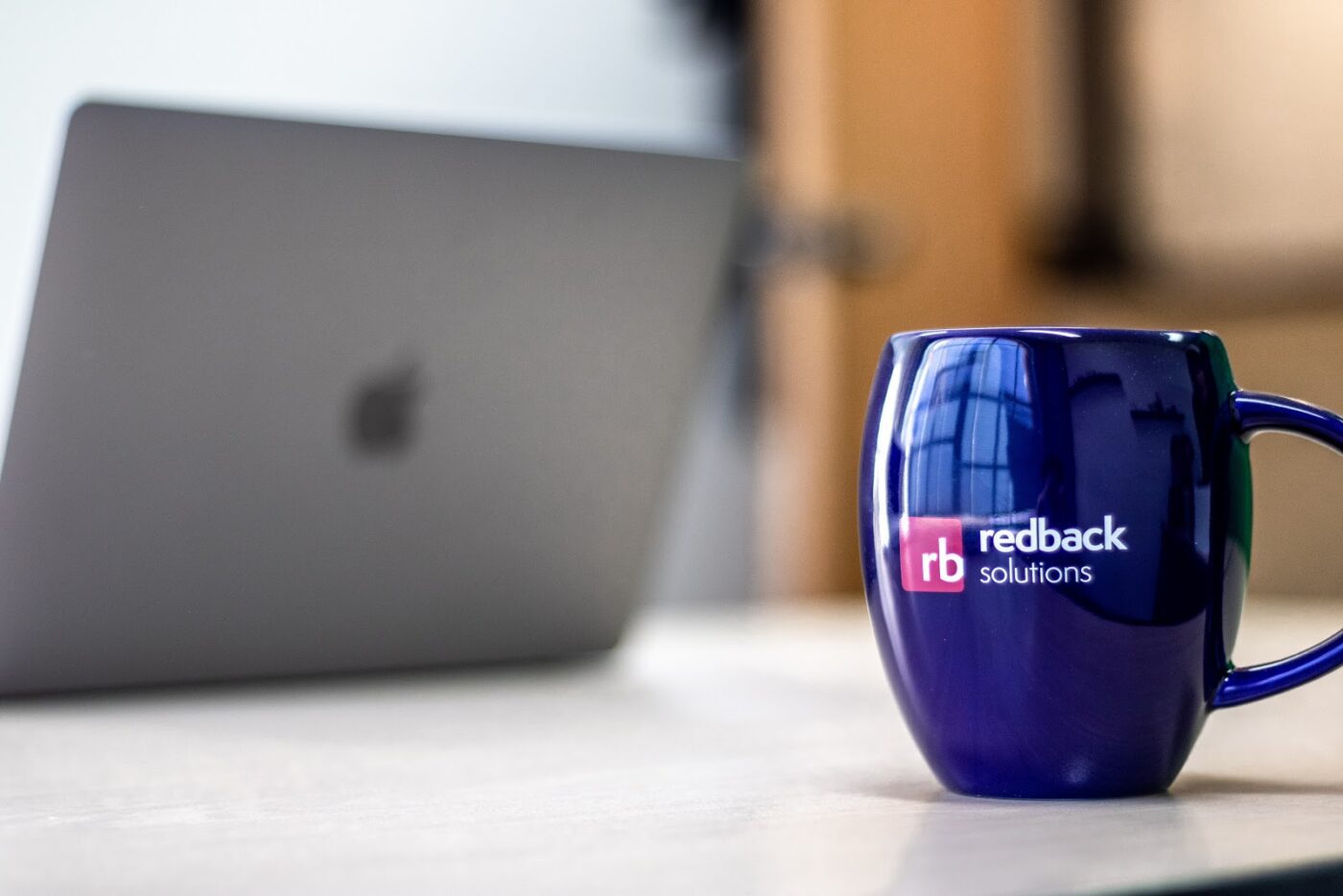 Redback Solutions mug and laptop