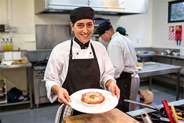 A chef presenting food