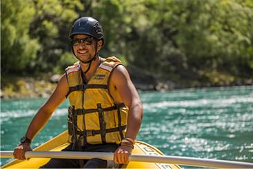 A man kayaks down a river