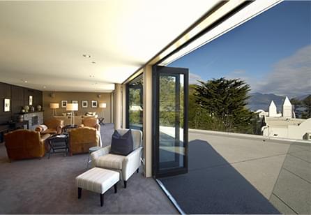 A room with bi-gold doors opening to a balcony