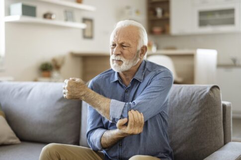 Managing-Arthritis-man-with-elbow-pain-min